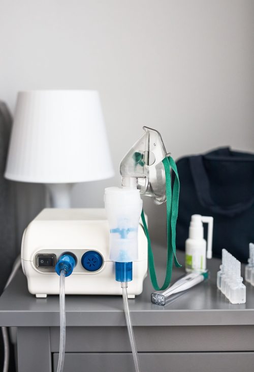 Nebuliser with breathing mask and medicines on bedside table Nebuliser with breathing mask and medicines on bedside table